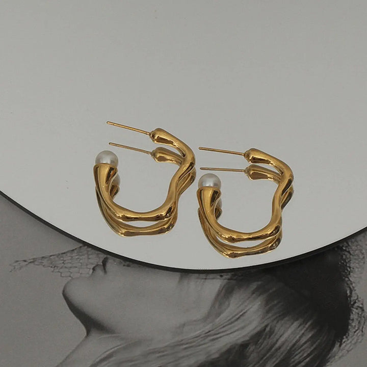 Boucles d'oreilles créoles ondulées dorées avec perle